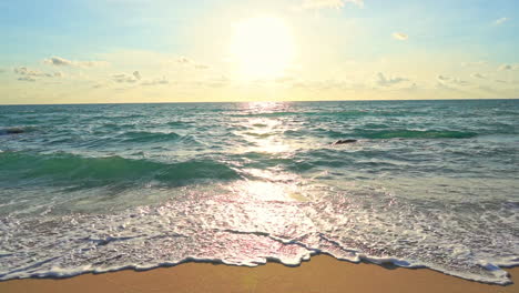 Warm-evening-sun-above-tropical-sea-water-and-empty-sandy-beach,-heavenly-scene-on-exotic-destination