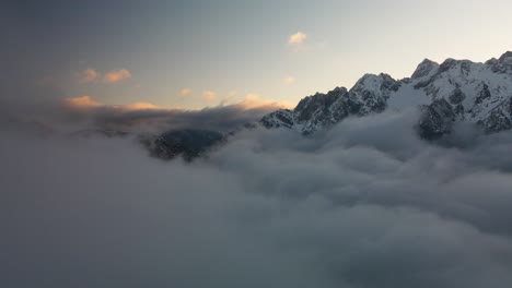 Flying-through-clouds-above-mountain-tops