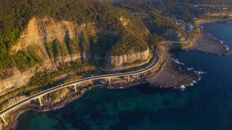 Oceanside-Sea-Cliff-Bridge-With-Vehicles-Traveling-During-Sunny-Moning-In-New-South-Wales,-Australia