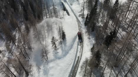 Aerial-top-down-of-snowplow-clearing-road