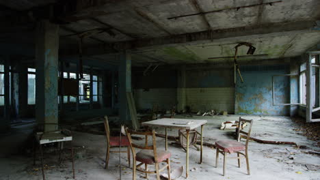Abandoned-commercial-building-with-furniture-in-Pripyat,-zoom-out-view