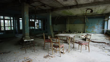 Antique-furniture-covered-in-dust-abandoned-in-Pripyat,-Chernobyl