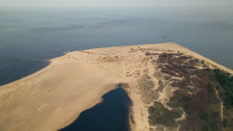 Aerial-top-down-of-sandy-beach-ans-coastline-in-Gdansk-and-calm-Baltic-Sea-in-backdrop