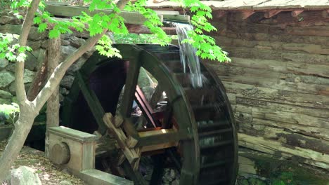 Big-Water-Wheel-as-a-part-of-Watermill-In-A-Zen-Garden-At-A-Korean-Folk-Village---medium-shot