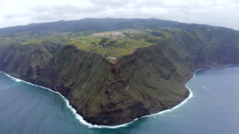 Drone-aerial-footage-of-Ponta-do-Pargo-lighthouse-and-huge-cliffs-on-Madeira-island,-Portugal