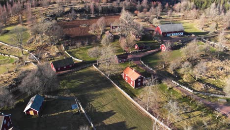 Drone-flyover-Åsens-by-Culture-Reserve-during-golden-hour,-Sweden