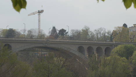 Wide-shot-of-pedestrians-walking-over-the-Adolphe-Bridge-in-downtown-Luxembourg