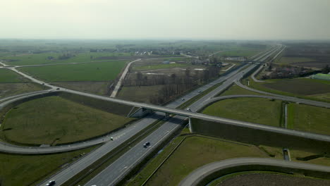 Aerial-drone-shot-of-new-modern-polish-Highway-with-traffic-in-rural-countryside-area-during-sunny-day