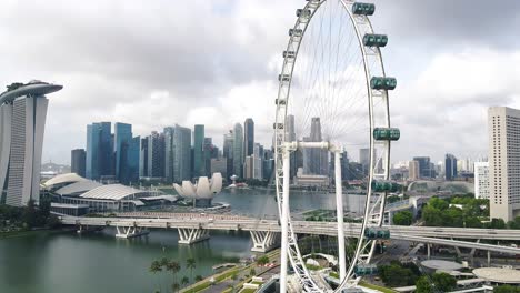 Aerial-drone-shot-of-Marina-Bay-futuristic-modern-city-skyline-with-Singapore-Flyer