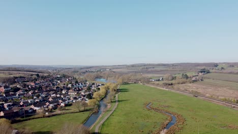 Small-town-alongside-River-Stour-Green-Chatham-Kent-countryside-aerial-rising-above-rural-landscape