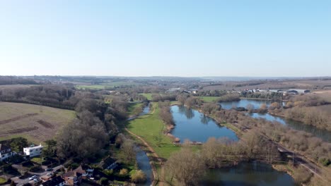 Flying-above-River-Stour-British-countryside-Chartham-Kent-blue-sky-rural-landscape