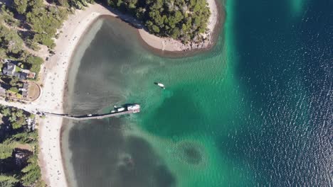 Vertical-aerial-of-wharf-in-clear,-shallow-Bahia-Brava-in-Patagonia
