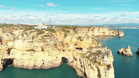 Picturesque-idyllic-view-of-Lagos-Coastline-Ponta-da-Piedade,-Algarve,-Portugal---Aerial-Wide-Panoramic-shot