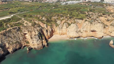 Colourful-Scenic-Coastline-Landscape-of-Lagos-in-Algarve,-Portugal---Aerial-High-slide-shot
