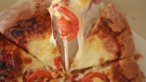 Picking-up-Slice-of-Pizza,-Cheese-Stretching,-Slow-Motion-Top-Down-View