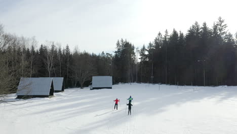 Toma-Aérea-De-Personas-Esquiando-En-Un-Campamento-De-Esquí-De-Invierno-En-La-República-Checa-Alpina,-Hermoso-Paisaje-Cubierto-De-Nieve