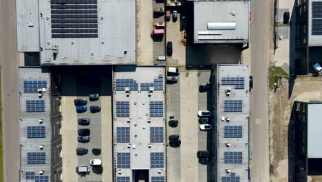 Top-down-aerial-of-solar-panels-on-top-of-industrial-warehouse-rooftops
