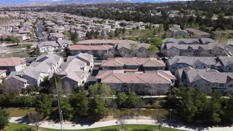Residential-neighborhood-of-houses,-aerial-daytime-view,-Valencia,-California