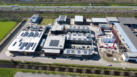 Wide-aerial-of-industrial-terrain-with-solar-panels-on-rooftop