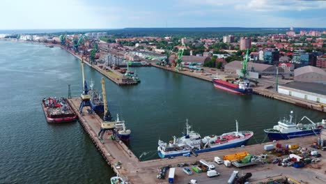 Aerial-View-Of-Port-Of-Klaipeda,-a-cargo-ship-terminal-on-the-shore-of-Baltic-sea-during-summer-In-Lithuania---drone-shot