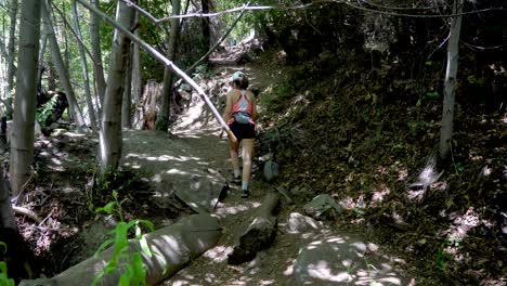 Young-Woman-Hiking-up-a-Shaded-Trail