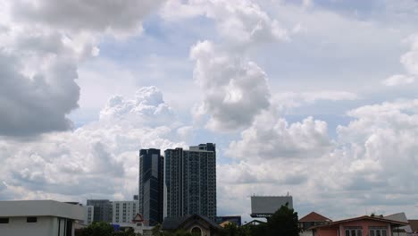 Time-Lapse-of-the-sky-moving-seeing-condominium-and-house-in-front-and-natural-daylight