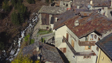 A-view-of-an-old-village-roof-tops-in-the-mountains-with-river-streaming