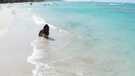 Bikini-model-drawing-on-sand-at-Maimon-Dominican-Republic