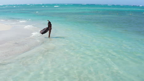 Solo-woman-in-bikini-on-idyllic-white-sand-beach-at-Playa-Teco-Maimon,-Dominican-Republic