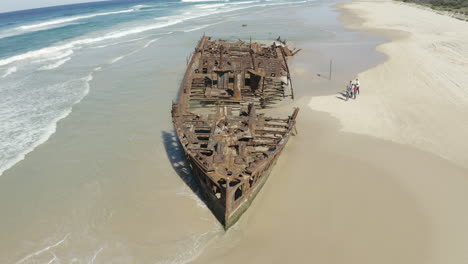 Drone-shot-of-the-old-shipwreck,-SS-Maheno,-on-a-beach-of-Fraser-Island,-Australia