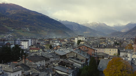 A-majestic-look-of-the-Valle-d’Aosta,-Italy,-with-amazing-clave-snow-capped-mountains,-and-rooftops,-A-Drone-view