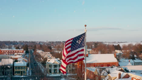 Snow-flakes-in-winter-with-American-flag-aerial