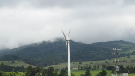 Wind-turbine-with-hill-valley-in-a-foggy-cloudy-weather-at-Queensland---static-shot