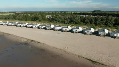 Aerial-View-Of-Holiday-Houses-In-Row-At-The-Beach