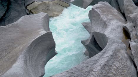 Fresh-cold-glacier-water-between-beautifully-shaped-stones,-marble-castle,-Norway