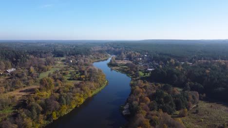 AERIAL-Slow-Fly-By-of-a-River-Nėris-Meandering-through-Autumnal-Forests-in-Vilnius,-Lithuania