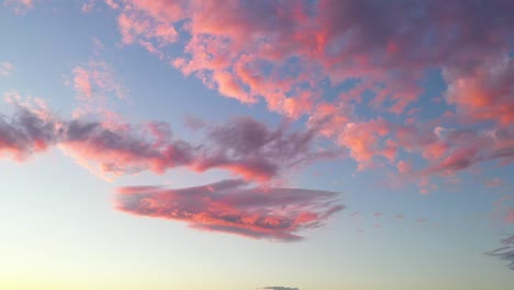 Beautiful-pink-fluffy-clouds-at-sunset,-skyscape-background