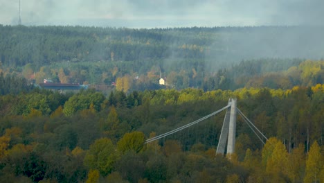 Timelapse-of-a-suspension-bridge-surrounded-by-green-lush-forest-in-Sweden
