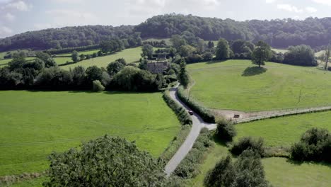 AERIAL---Country-road-and-hills-near-Uley,-Cotswolds,-England,-forward-shot