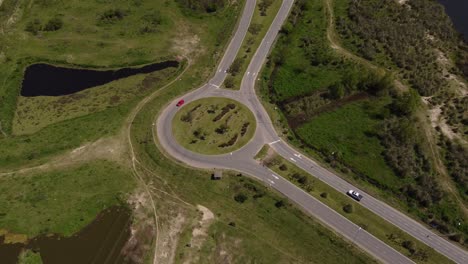 Aerial-birds-eye-shot-of-cars-driving-in-roundabout-in-rural-area-of-Buenos-Aires-near-River-Plate,Argentina