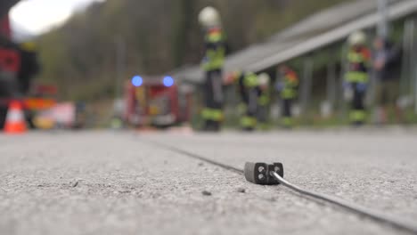 fire-fighters-on-car-crash-scene,-blue-lights,-blurry-background,-slow-motion