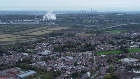 Aerial-view-above-Halton-North-England-Runcorn-Cheshire-countryside-smoking-industry-landscape-tilt-up-pull-back