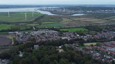 Aerial-view-above-Halton-North-England-Runcorn-Cheshire-countryside-wind-turbines-industry-landscape-slow-pull-back
