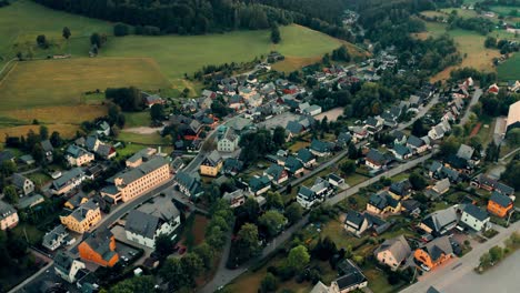 german-town-of-Seiffen-extending-between-high-green-hills,-Aerial-view