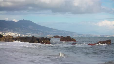Waves-hitting-the-rocks-at-the-beach-in-slow-motion