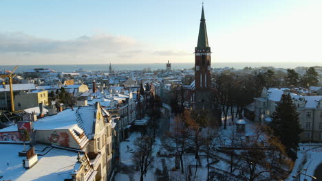 Aerial-view-drone-pitch-up-motion-unveiling-Sopot-city-urban-winter-landscape-with-Garrison-Church-of-St