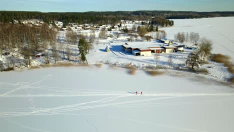 Two-people-skiing-on-a-frozen-lake-on-a-cold-sunny-day