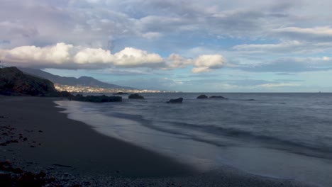 Timelapse-of-Playa-Penon-Del-Cura-with-town-on-the-background