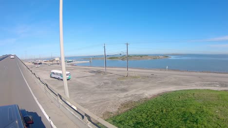 Roof-top-point-of-view-while-driving-up-the-bridge-over-the-shipping-channel-in-Laguna-Madre-on-JFK-Memorial-Causeway-at-Corpus-Christi-Texas