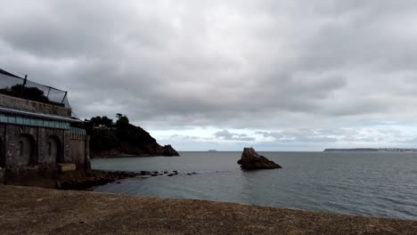 Time-lapse-shot-showing-ocean-shore-and-moving-dark-clouds-in-Torquay,South-Devon